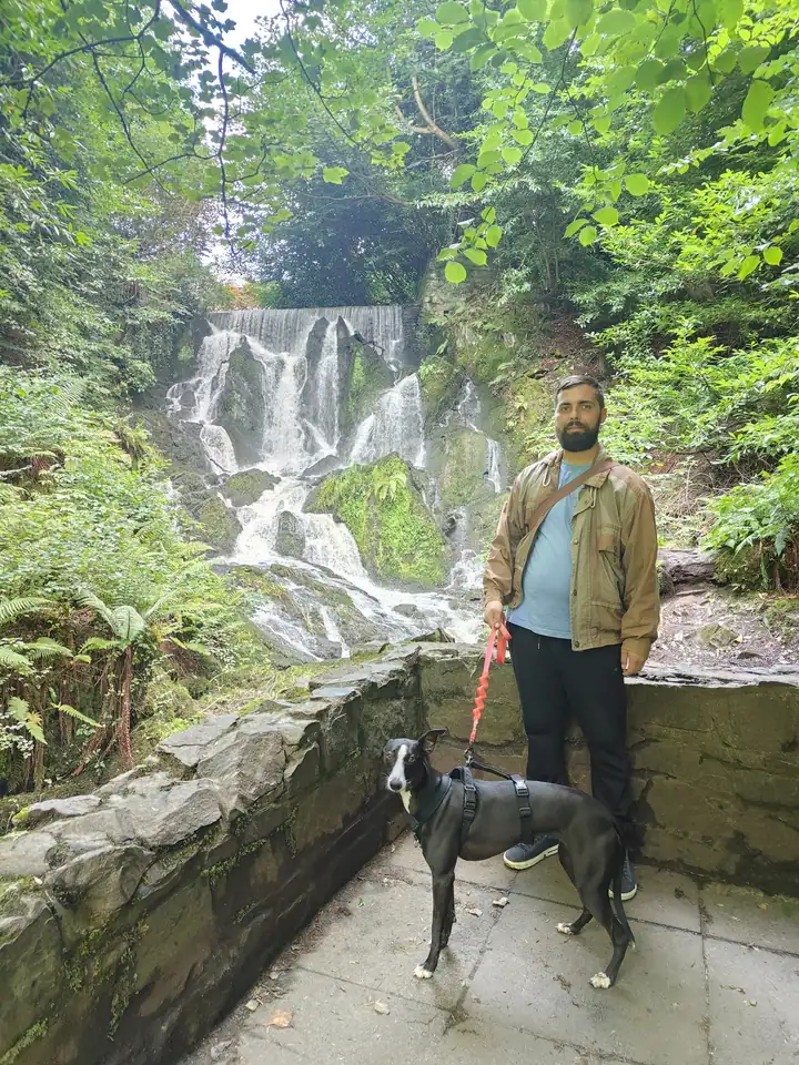 Alin and Santa together beside a woodland waterfall