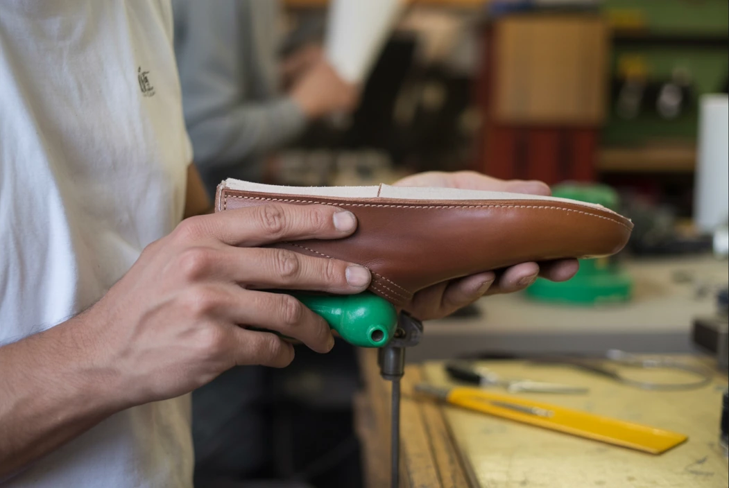 worker in a barefoot shoe factory crafing barefoot shoes