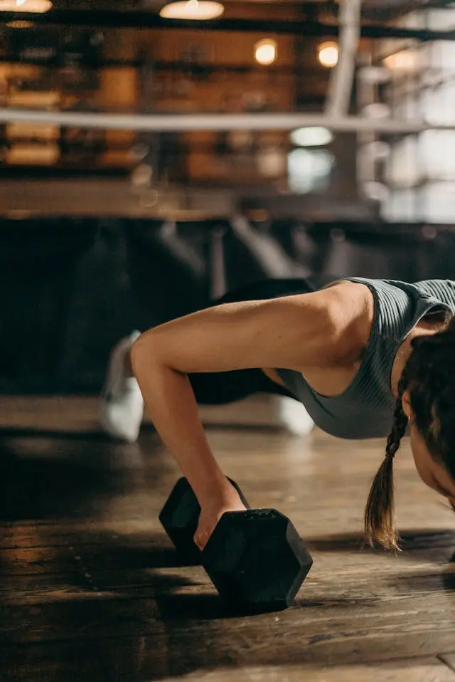 woman doing strength training in the gym while wearing the xero shoes kelso