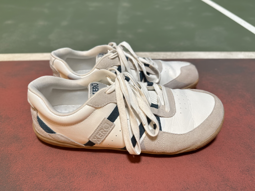 the xero shoes kelso next to a court which is possibly a tennis or pickleball court