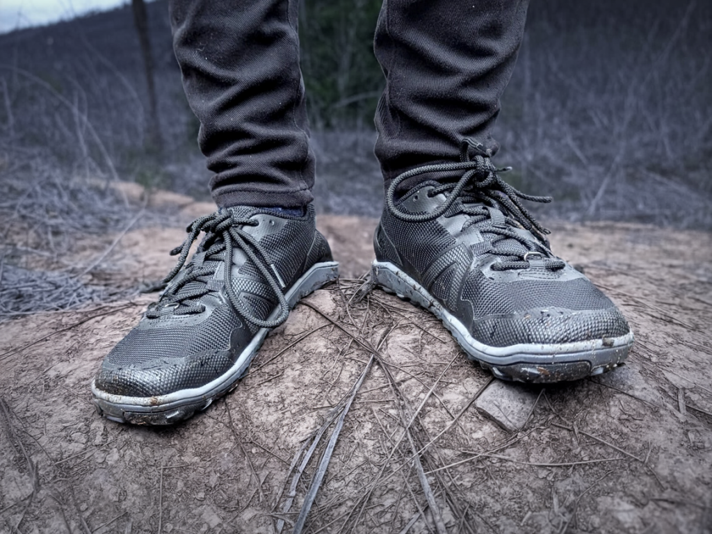 wearing the xero shoes scrambler low ev black barefoot shoes on a hike in the forest