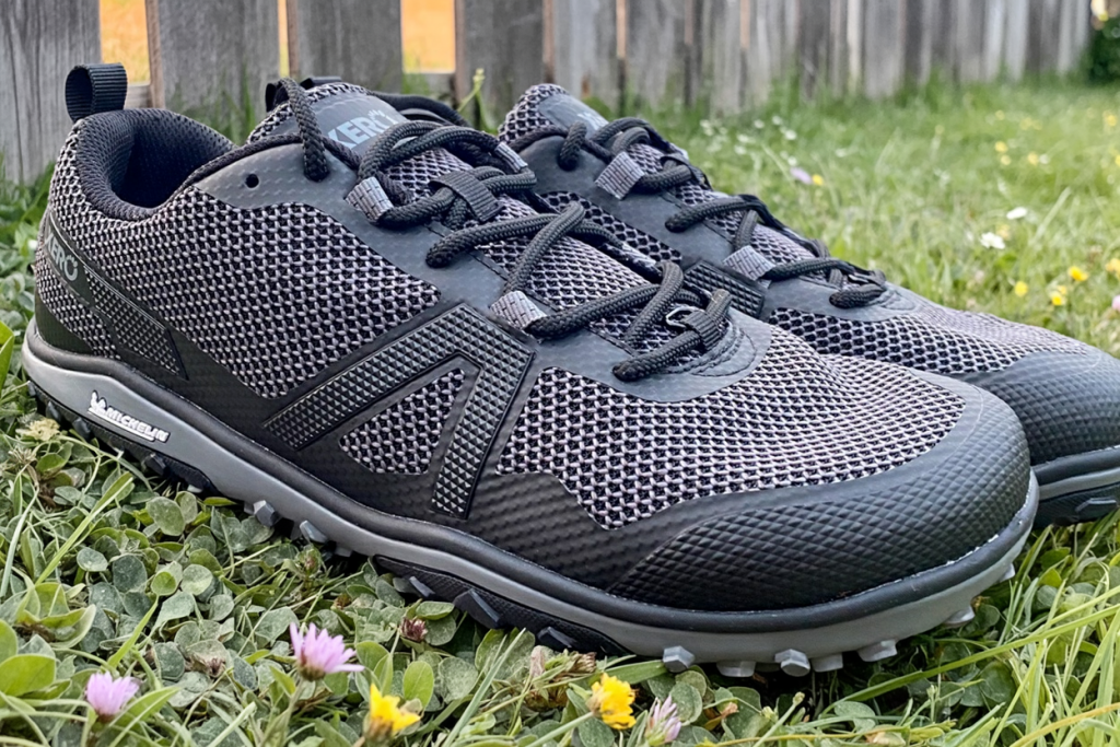 Xero Shoes Scrambler Low EV black model pictured outdoors in the grass - close-up of the monofilament mesh upper