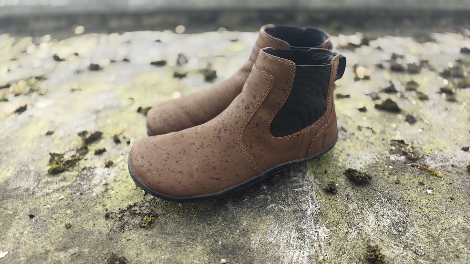 Freet Durham boots on wet mossy stone showing DWR water repellent performance