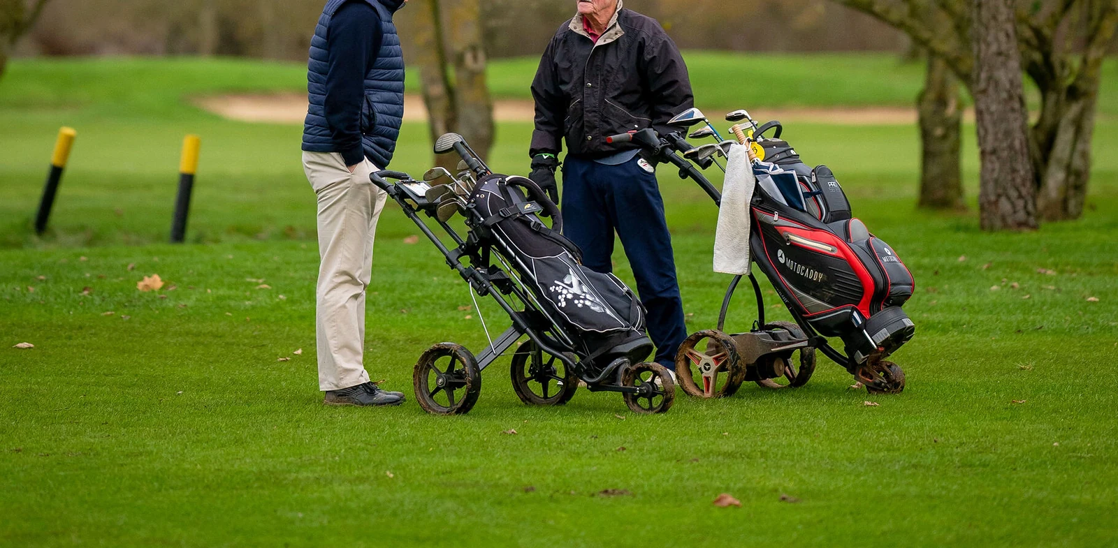 Golfers walking on a fairway in barefoot golf shoes