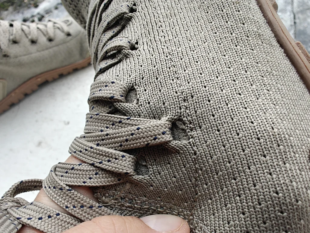 Freet Danum: Laces passing through the knit openings.