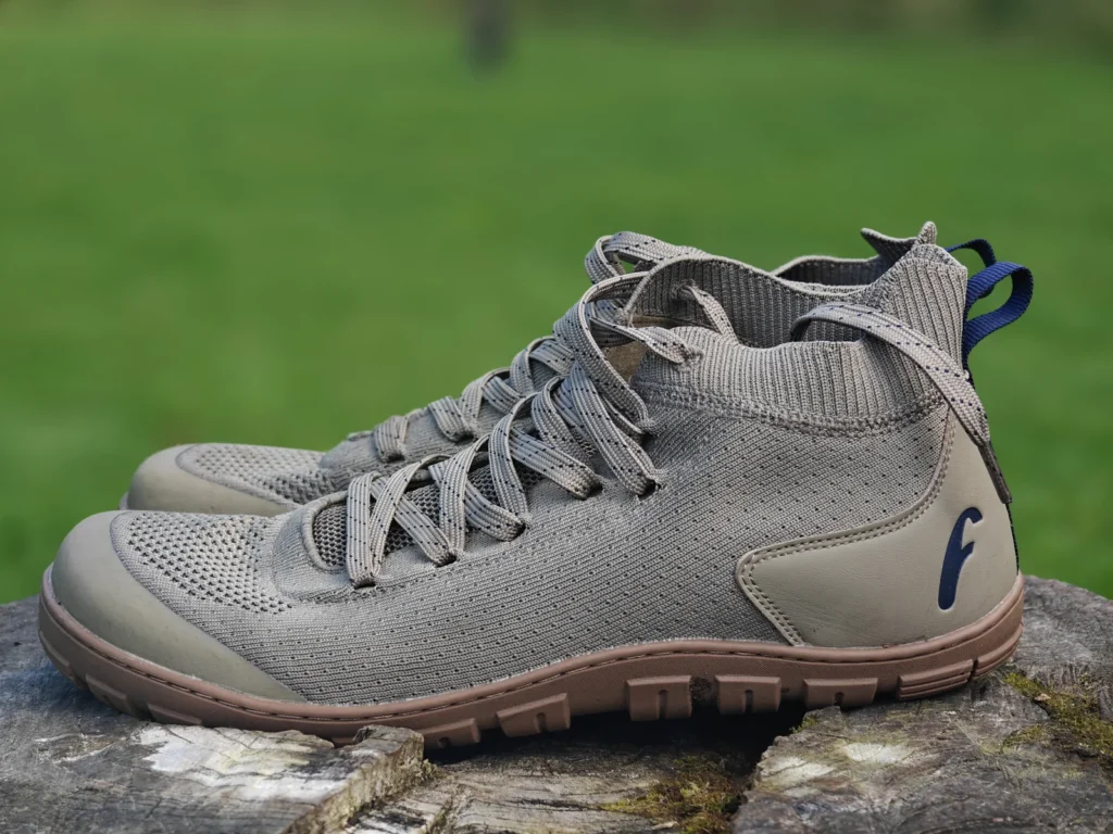 Grey-olive Danum boots on a stump, showing the knitted collars and uninterrupted mesh sides.
