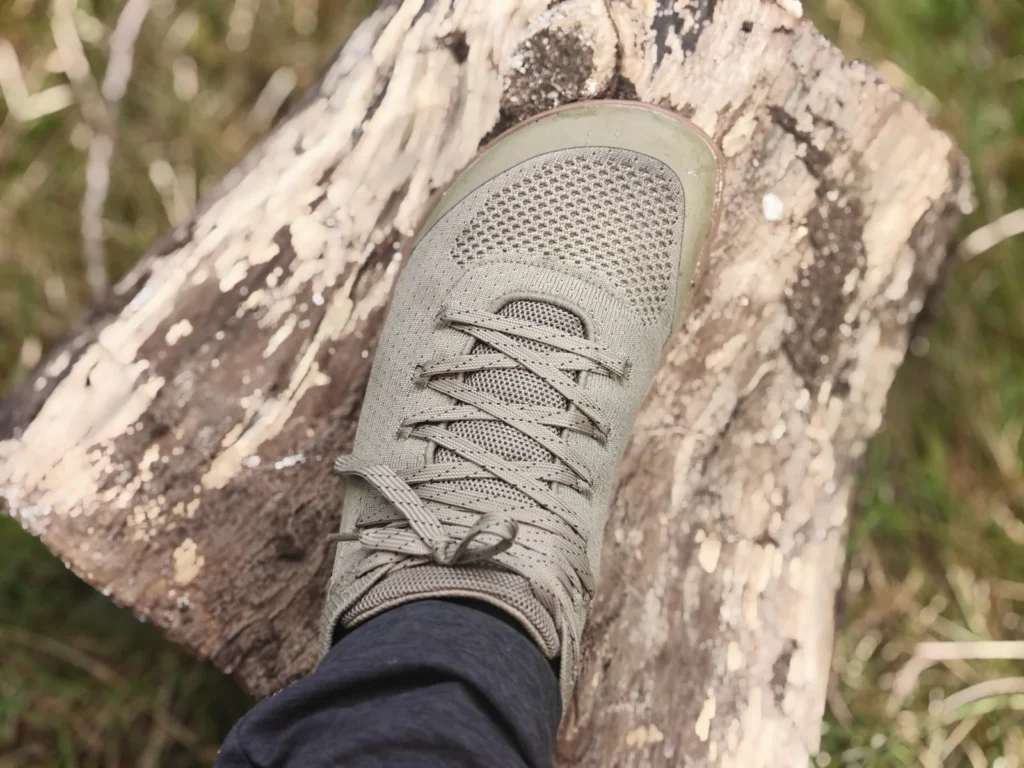 Top-down view of the right Freet Danum shoe on a foot resting on a fallen log.
