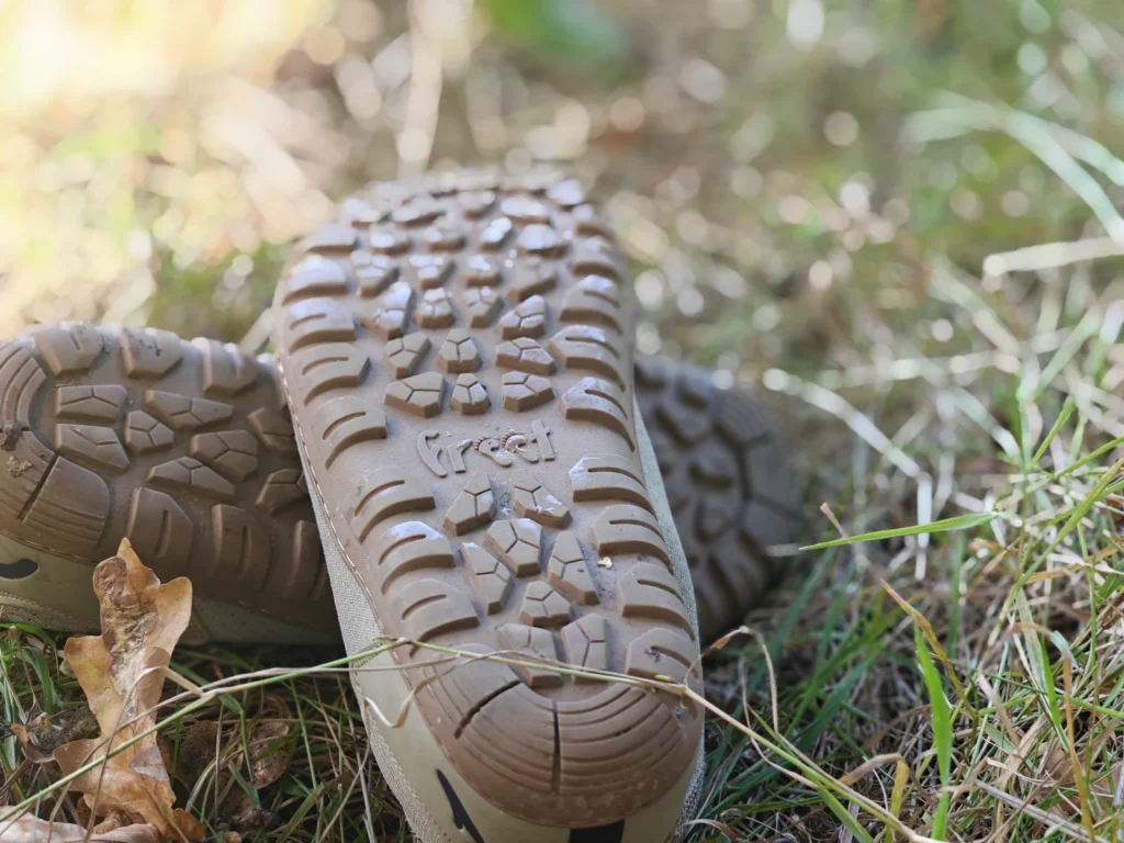 Underside view of the full Freet Danum rubber outsole after roughly 100 miles, showing tread lugs and siping grooves.