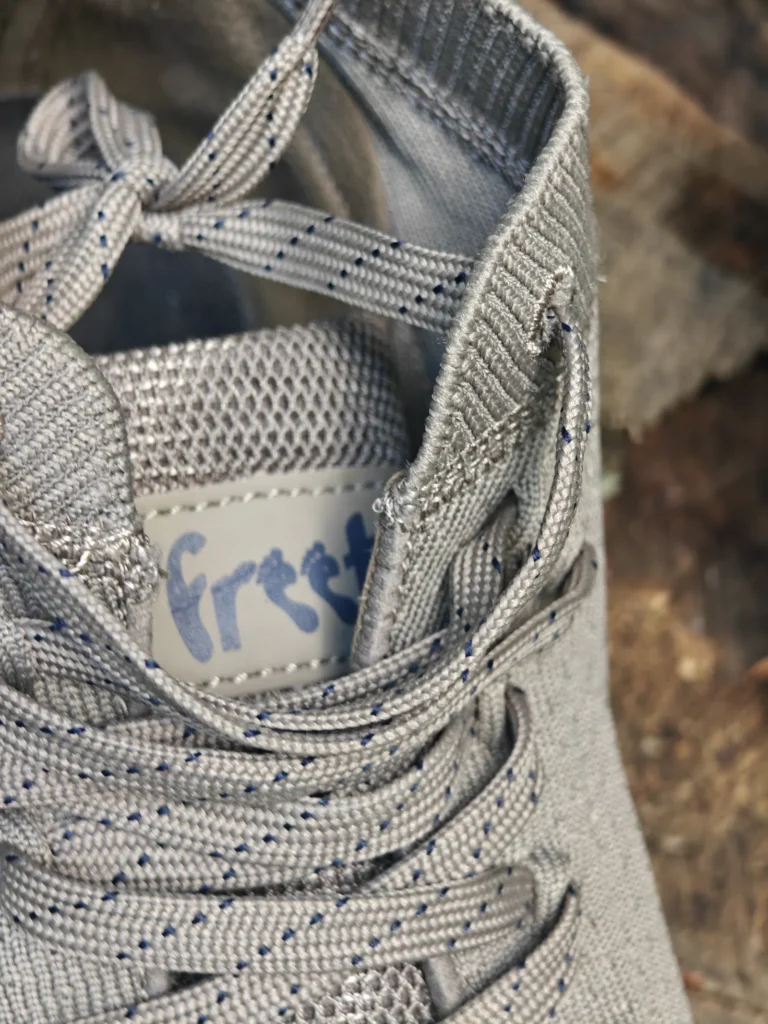 Top-down view of the Freet Danum tongue patch with lowercase freet lettering, dashed laces, and ribbed collar.